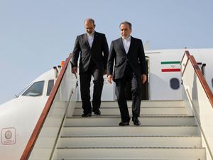 Iranian foreign minister Abbas Araghchi, right, arrives in Muscat, Oman