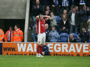 Walsall boss Chris Hutchings has blamed skipper Mark Hughes for conceding the penalty which led to the Saddlers crashing 2-1 at Colchester in League One.