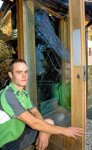 Rod Davies with the smashed door at Blazing Bikes in Marshbrook