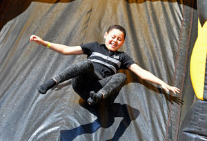 Fabian Ogude, 9, enjoys the inflatable slide 