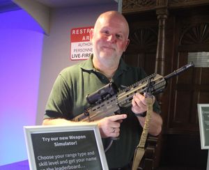 Weapons demonstrator Stuart, holding the museum’s weapons simulator SA80 rifle. 