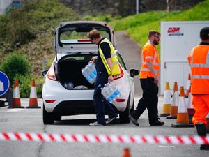 People collecting bottled water at Freshwater car park in Brixham.