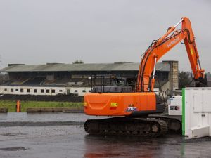 A digger in front of Casement Park