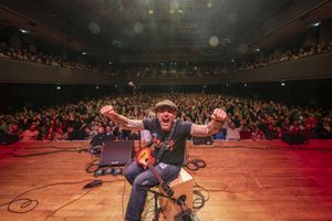 Jonny Cole on stage with the crowd behind him at the Wolverhampton Civic Hall.