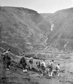 The mountain rescue unit, with stretcher and rescue equipment, set off on a mission in the Peak District in 1960