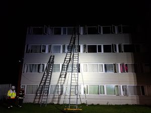 Ladders were used to rescue residents from the four-storey building. Photo: Andy Smith