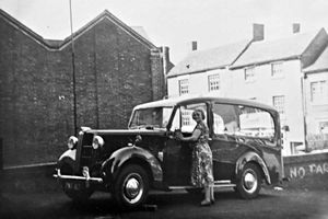 Mary Brown is pictured polishing the Austin hearse.