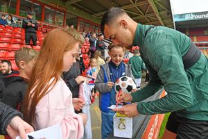 Taylor Allen gives out his autograph.