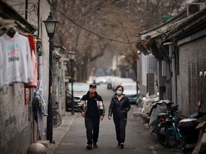 Local walk along an alley way in Hutong area in Beijing