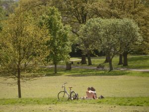 People enjoy the warm weather in Brockwell Park near Herne Hill, London. (PA)