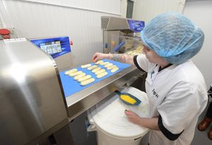 Kelly Stojeck on the chocolate enrobing machine