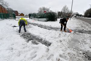 The scene around Aldridge after heavy snowfall.Clearing the pathway at Barr Beacon School.