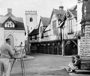 September 1962: 'In the long shadows of the late afternoon sun, artist Mr. W.H.C. Twist, of Newport, paints by the Old Butter Cross in the village centre at Much Wenlock.'