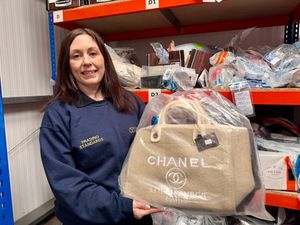 Trading Standards Officer Laura Burgess holding some seized counterfeit goods.