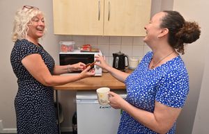 Ann shares a joke with staff member Helen Wassell 