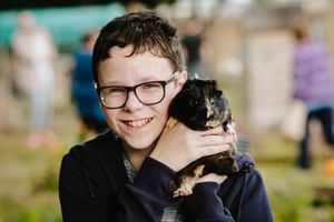 Children at Longlands Community Primary School in Market Drayton have invited local residents into the community to visit their eco-garden and animals. In Picture L>R: Former pupil and local resident, Alex Keen 12 with Freya