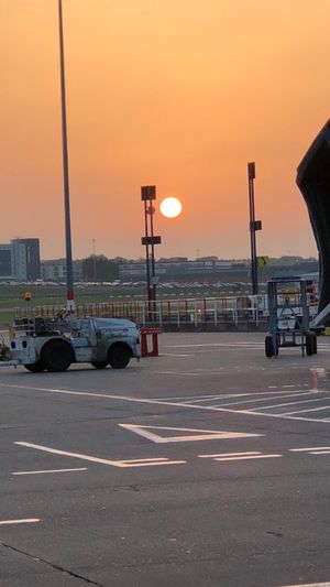 The sun and sky rising above Birmingham Airport. Credit: @dixonbeats