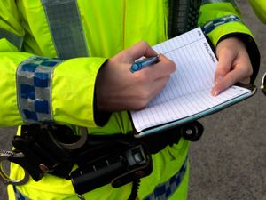 Police officer writing in a notebook