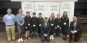 Deputy council leader Cllr Matthew Dorrance and director of education, Dr Richard Jones with Ysgol Golwg y Cwm pupils with Simon Page and Kirsten Mackay of Child Poverty Action Group, at the Child Poverty Task Force conference which was held in June