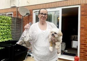 Celine Lockyer with her dog Milo and the egg boxes recovered from an alley after the attack on her Worcester home.