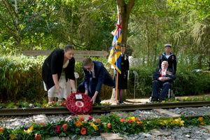 Second World War veteran Alfred Conway (right) from Lincolnshire, who served with the Royal Navy, watches on as his great-grandchildren, Sarah-Jayne Carpenter (left) and James Carpenter (second left) lay a wreath on the Burma Thailand Railway memorial at the National Memorial Arboretum, during a reception for VJ veterans and their families hosted by the Royal British Legion at The Aspects Building, following a national Service of Remembrance to mark the 80th Anniversary of VJ Day at the National Memorial Arboretum in Alrewas, Staffordshire.  Picture date: Friday August 15, 2025. PA Photo. Photo credit should read: Danny Lawson/PA Wire 