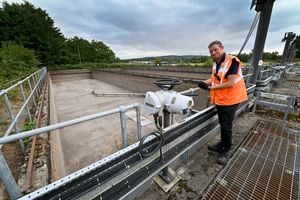 Andy Bradford standing next to the storm tanks