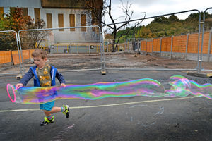 Children enjoy being outside in the half of the playground that was saved from the fire
