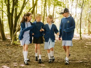 Pupils love playing outdoors and building dens in the forest school. 