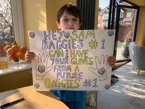 Brandon shows off his sign beforehand. 