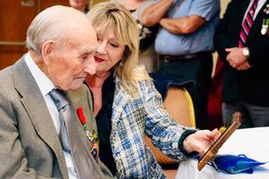 Bill Bray admires the plaque that he received from Albrighton Parish Council with his daughter