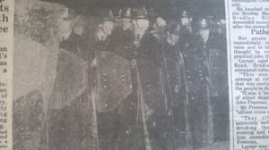 Police line up behind riot shields as they run the gauntlet of petrol bombs, bottles and stones in Farndale Avenue, Whitmore Reans