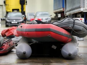 Small boats and outboard motors thought to be used by migrants crossing the Channel