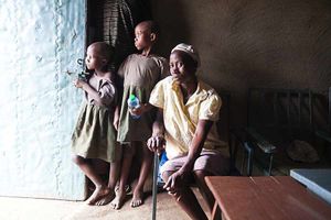 Charlotte Omonbi with her children Hanshallot, aged six, and Reice, aged eight, at their home