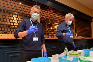 Pharmacists Calvin Cheung and Martin Wilson, mixing the vaccine