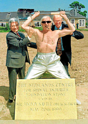 Jimmy Savile and Wagim El Masry Director of the Centre of Spinal Studies and chairman Richard Burbidge at the Oswestry Orthopaedic Hospital for the unveiling of the plaque in 1999