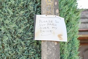 A sign reading, ‘Please do not park over my drive’ erected near the West Midlands school.