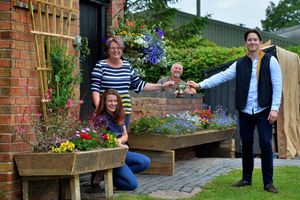 Alexander Newport presents a trophy to competition winners Sarah Marshall and daughter Maddie Sanderson 