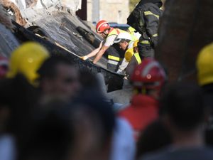 Rescue workers search for victims