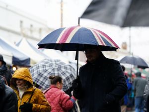 People holding umbrellas in wet weather