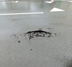 A hole caused by heavy rain in Redhall Road