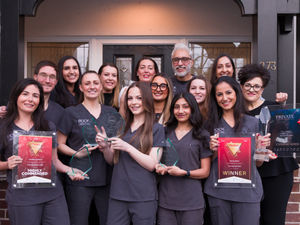 Rock Dental’s multi-award-winning team outside 273 Tettenhall Road, displaying their 2025 trophies and previous honours.
