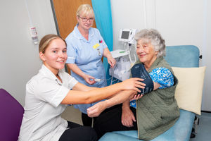 Freya Weetman, Student Nurse Associate, and Patsy Gardner, Staff Nurse, carrying out an early health screening on patient Glenys Owens, aged 90. 