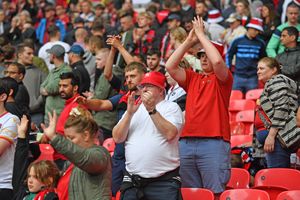 Walsall fans salute the players