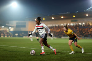 Melvine Malard of Manchester United runs with the ball under pressure from Becky Anderson of Wolverhampton Wanderers (Photo by Naomi Baker/Getty Images)