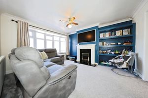 The generous living room enjoys a large bay window 