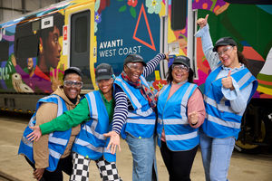 Onboard Customer Service Assistant Marvia Norman (centre) at the unveiling of a new train wrapped in a bespoke artwork designed to celebrate the ethnicity of employees and communities across its network