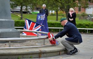 Roy Whitehead lays a wreath as organiser Rose Cook-Monk watches on