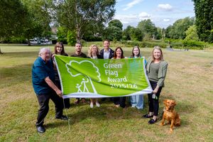 Councillor Carolyn Healy, Telford & Wrekin Council Cabinet Member for Neighbourhoods, Planning and Sustainability, far right, and Councillor Peter Scott, Ward Member for Newport West, far left, with staff celebrating the Green Flag award for Victoria Park.