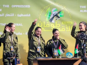 Israeli female soldier hostages Naama Levy, Daniella Gilboa, Karina Ariev and Liri Albag, in no particular order, salute a Palestinian crowd