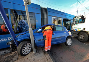 The car was wedged between a lamppost and the tram